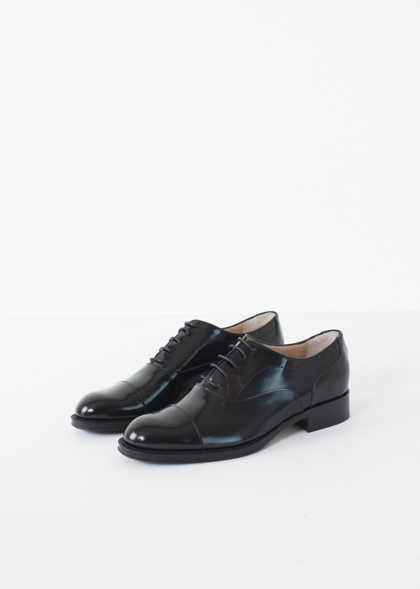 Classic Brogue in black leather with a polished finish, featuring traditional wingtip detailing.