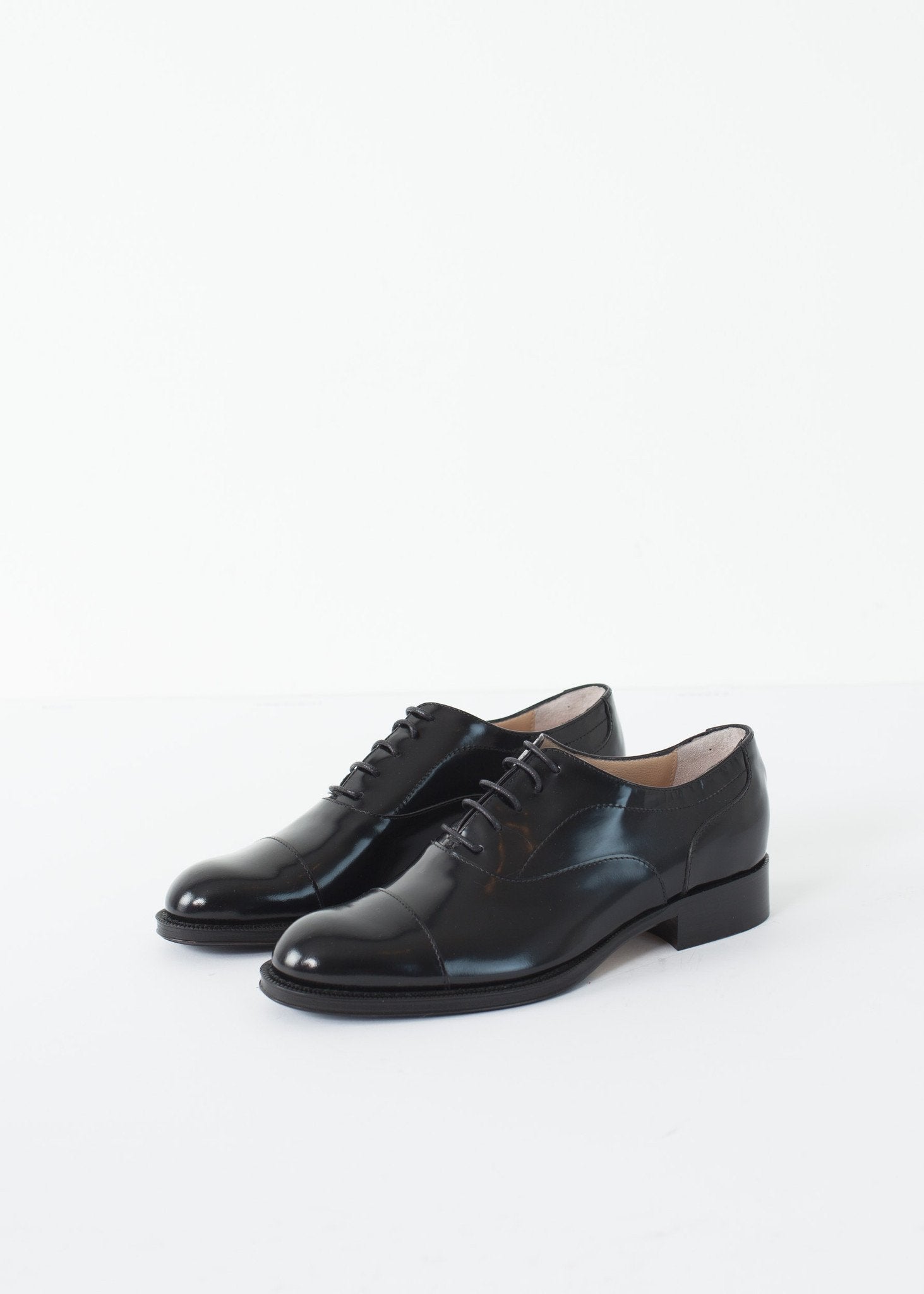 Classic Brogue in black leather with a polished finish, featuring traditional wingtip detailing.