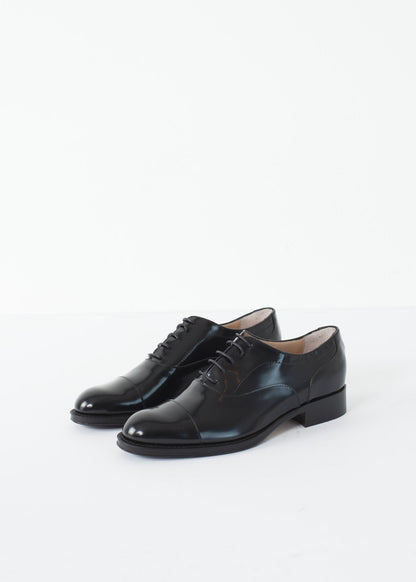 Classic Brogue in black leather with a polished finish, featuring traditional wingtip detailing.
