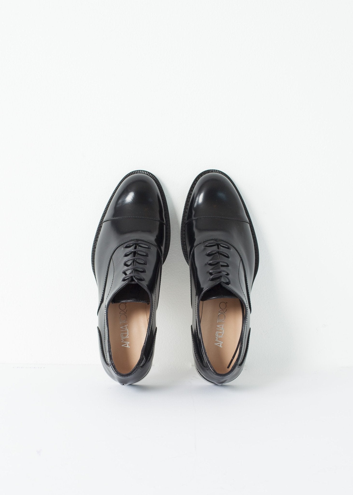 Classic Brogue in black leather with detailed stitching and lace-up design. Perfect accessory for any outfit.