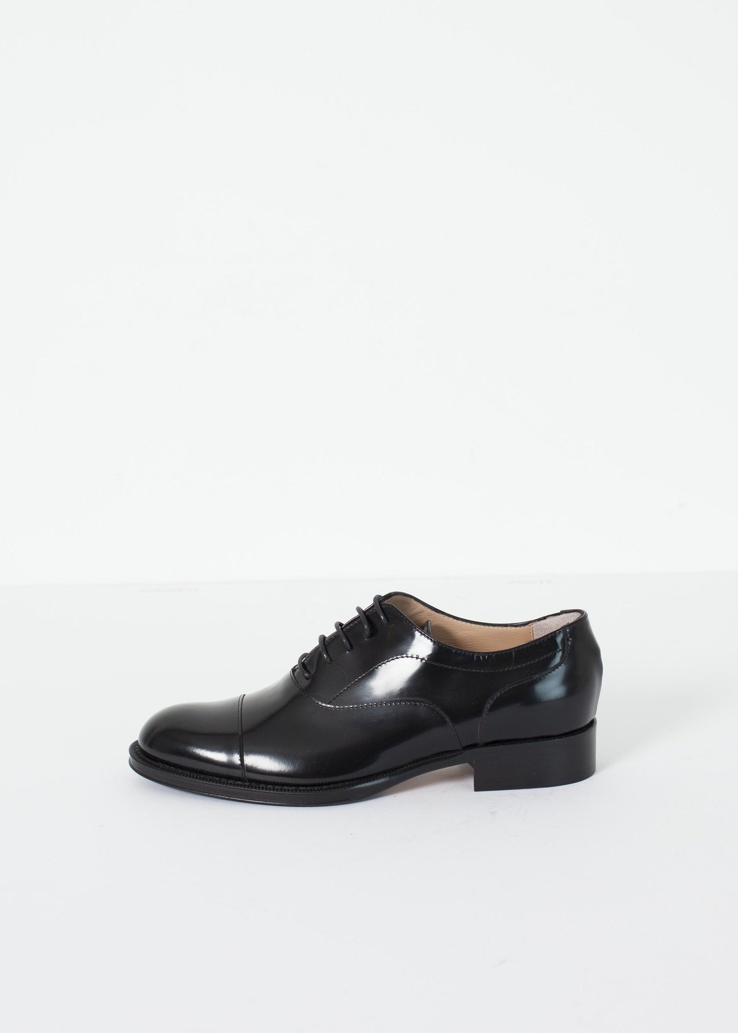 Classic Brogue in black leather with a polished finish and lace-up design.