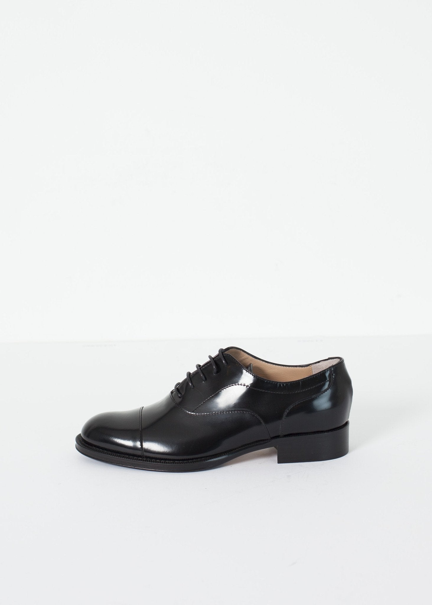 Classic Brogue in black leather with a polished finish and lace-up design.
