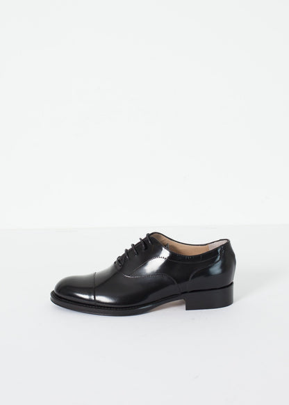 Classic Brogue in black leather with a polished finish and lace-up design.
